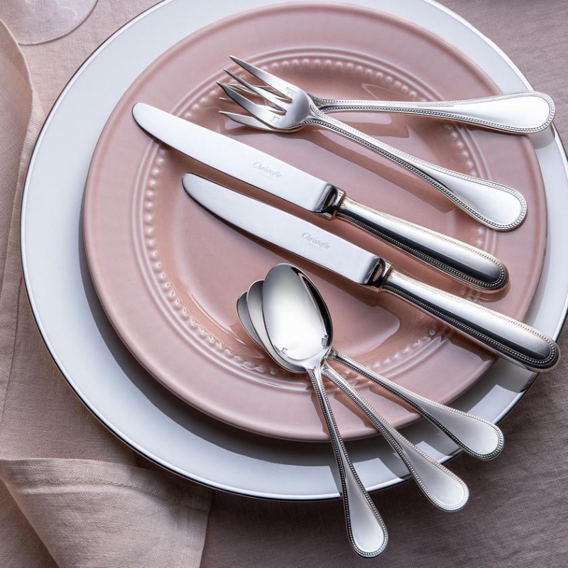 PERLES collection. Pearls, Louis XVI style, was created in 1876. The alignment of pearls in semi-relief is one of the typical ornaments of Louis XVI decor. This classic and feminine decor highlights the outline of the cutlery like a pearl necklace.
