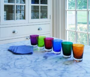 MOSA√èQUE tumblers set. Handcrafted using traditional glassblowing techniques, these glasses are the perfect gift! Available in a set of 6 in 6 different colors. The tableware has a simple silhouette that is precise and elegant. The understated shape of the tumblers makes their use appropriate for any and all drinking experiences: as a water or fruit juice glass, or mixed in with Baccarat clear crystal bar sets. The hand-blown MOSA√èQUE tumblers are cased in clear crystal, and are available in a vast array of cheerful colors in this set: orange, blue, purple, moss, green, and Baccarat‚Äôs signature ruby red crystal. The interplay of light with the smooth surface and the colored crystal makes for a radiant table, and a compelling soir√©e.