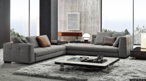 BLAZER seating system by RODOLFO DORDONI, designed in 2020. The key feature of the design is the backrest with rounded internal corners, which creates a comfortable, enveloping niche, transforming the chaise-longue element with tall backrest and armrest into a particularly welcoming alcove.