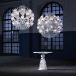 LE ROI SOLEIL chandelier by MARCEL WANDERS Studio. This majestic chandelier, a contemporary twist of the iconic Z√©nith chandelier, is revealed under a new light thanks to its current and timeless spherical figure. Cabled arms in the grand tradition of glassmaking and its round shape-cut curved crystal lampshades have been specifically conceived to draw a perfect spherical shape. Spiked prisms, festoons of octagons and scrolls come adorning this 40L chandelier. A red crystal octagon represents the Baccarat signature and is linked to a spiked prism signed by MARCEL WANDERS Studio. Chandelier ompatible with chains and canopies for 36-48L chandeliers.