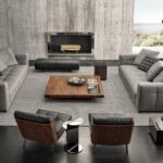 BLAZER seating system by RODOLFO DORDONI, designed in 2020. All the surfaces of the elements feature stitching, designing evenly-spaced bands on the covering of the base, cushions, armrests and backrest, and creating a quilting effect that identifies its look and instantly provides a sensation of comfort.