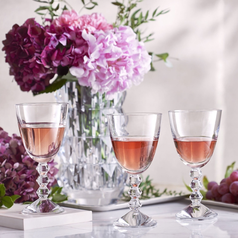 The V√âGA  Clear crystal glass has a sleek and modern silhouette. The geometric stem is eye-catching: three stacked diamond-shaped silhouette resembles exquisite beads strung together or Brancusi‚Äôs geometric totems.  Designed for Baccarat by SAVINEL & ROZ√â , the upper smoothness is juxtaposed with lower angularity: the curvature of the bowl contrasts sharply with the bevel-cut zigzag of the stem. The innovative form adds to the enjoyment of sipping a quality vintage. The Vega set also includes a champagne flute, martini glass, and other bar and tableware.