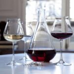The CH√ÇTEAU Baccarat decanter has a sharp aesthetic and contemporary design that expertly melds form and function. Decanting a wine releases its aromas and smoothes out the tannins. Inspired by the taste-vin silhouette that sommeliers use, this shape aerates the wine and allows it to achieve its fullest aromatic body. The wide base tapers at the neck to opens up the notes and fill the vessel with a concentration of rich complexity. The CH√ÇTEAU Baccarat collection takes into account the changes in the wine market and has, accordingly, crafted a stylish and cunning shape. Perfectly suited to the discerning vintage connoisseur, it is a sophisticated bar accessory worthy of any festive soir√©e. The CH√ÇTEAU Baccarat wine glasses complement the decanter with their equally exquisite form.
