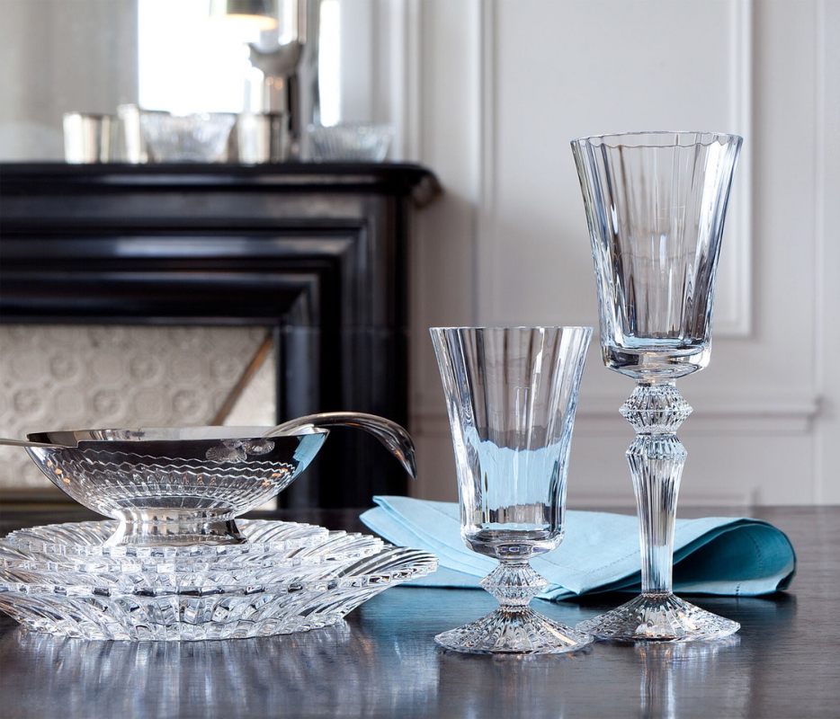 Designed by MATHIAS for Baccarat, the name MILLE NUITS is a reference to the 1001 Tales of The Arabian Nights, and to the world of the Orient. The signature of the MILLE NUITS set is the elegant diamond-cut center, which sits just between the bowl and the top of the stem. The MILLE NUITS collection is also comprised of champagne flutes available in a variety of vivid colors. Within tableware, the MILLE NUITS collection extends to decanters and plates. Within the home d√©cor category, the collection extends to chandeliers, lamps, candelabras.