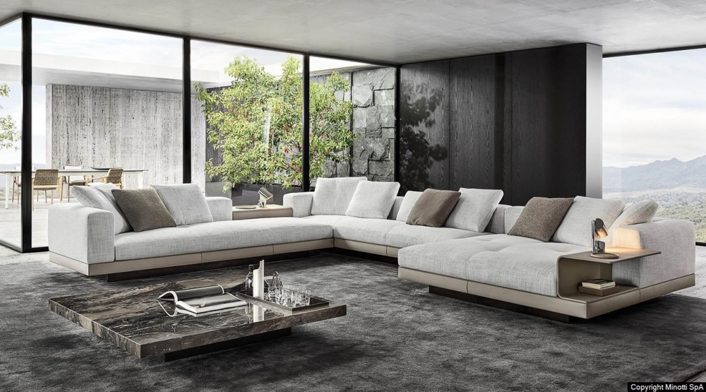CONNERY seating system by RODOLFO DORDONI, designed in 2020. With its geometric rigour, the base creates an original contrast with the softness of the seat, conceived as a single cushion punctuated by light stitching defining the width of the seat ‚Äì 83 or 68 cm ‚Äì and with the structure of the backrest and armrest, covered in channelled goose down padding. The backrest and armrest form a single volume, with a 45¬∞ split in the corner.