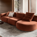 GINZA sofa designed by ELLEN BERNHARDT and PAOLA VELLA. GINZA  is a sofa system with sinuous and sensual shapes. Inspired by organic shapes reminiscent of 1970s design, it transforms any space into a warm and familiar landscape, spreading a pleasant sense of home comfort. Soft and enveloping lines recur in all the elements of the collection, which includes various modules that allow the creation of linear compositions, angular or unu-sual shapes, always characterized by the play of shapes and a cozy looking depth.