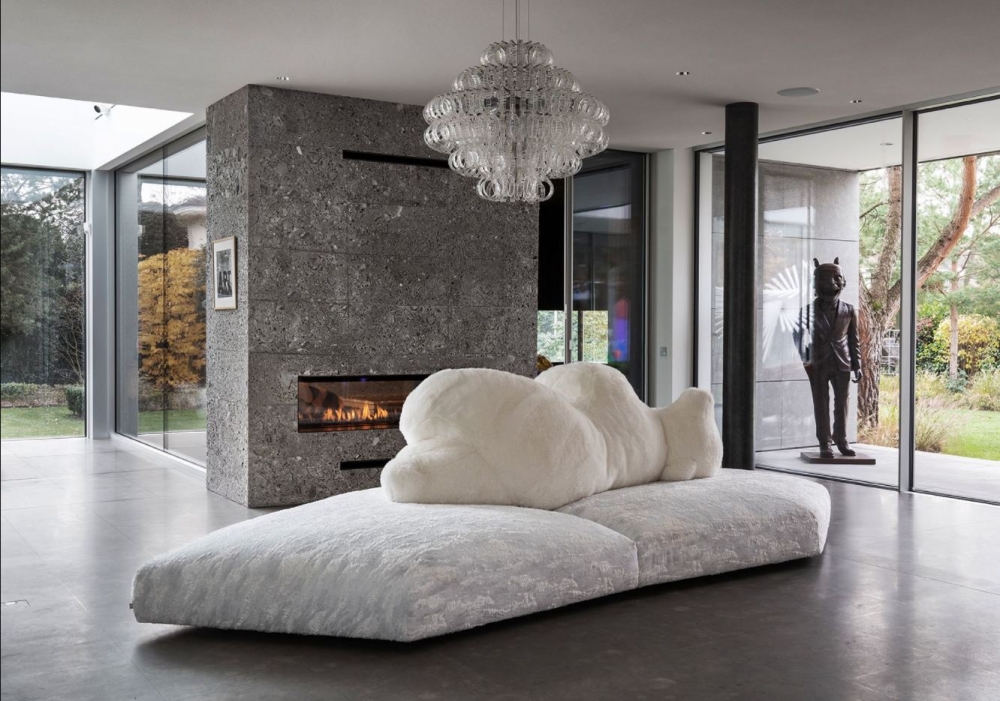 PACK sofa by FRANCESCO BINFAR√â. An icepack as a base. A bear lying on its side as a backrest. The seat is padded with gellyfoam and feather, covered with a special fabric with a texture similar to ice layers. The backrest is soft, made of polyester and covered with ecological fur. Leaning over, the big bear that supports, embraces and welcomes, for a relaxing finally freed from any constraint. The shape of the base, composed of two parts,  is irregular, and corresponds to a right angle of three meters and seventy centimeters for two fifty. Available in black or white.