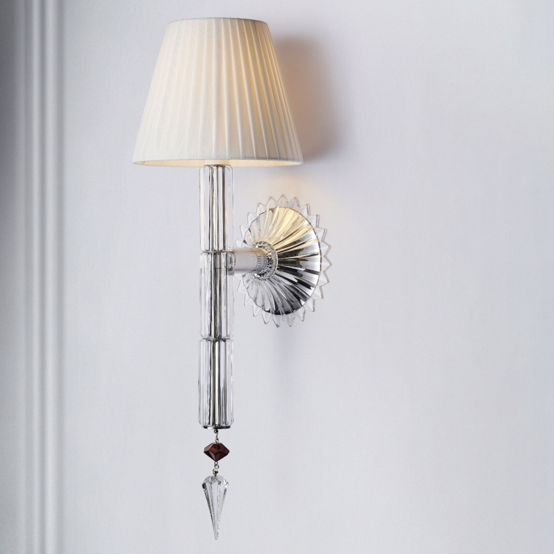 MILLE NUITS wall unit ‚ÄúFLAMBEAU‚Äù. The ¬´FLAMBEAU¬ª wall unit creates a beautiful light atmosphere. Covered with crystal and topped with a pleated fabric lampshade, it brings a perfect touch of elegance from the hall to the living room. The central part in beveled-cut crystal ends with a red hexagonal bead carrying the Baccarat and MATHIAS signatures and a clear prism, reminding the Mille Nuits chandeliers.
