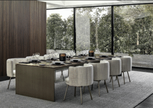 LINHA DINING TABLE by MARCIO KOGAN (STUDIO MK27), designed in 2020. In the more sculptural version, the frame designs a bridge, the top flush with the sides, whereas in the other tables the blade-like legs are set back from the surface.