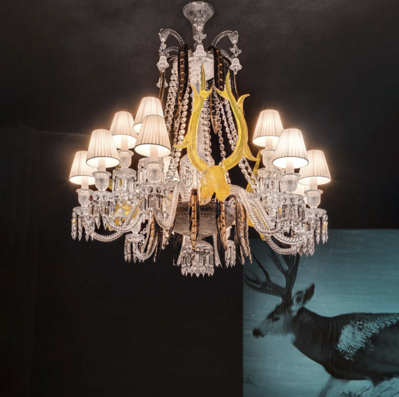 Crystal chandeliers √âTRANGE Z√âNITH DEERS. Imagined by PHILIPPE STARCK in collaboration with glassware artist ARISTIDE NAJEAN, the ¬´ Z√âNITH SUR LA LAGUNE ¬ª adorned with the heads of deer is a magic combination where Baccarat crystal meets Murano glass. 15-light chandelier based on a 24-light Z√©nith chandelier in clear crystal consisting of 15 twisted Z√©nith arms, 3 acid yellow deers and 18 black and gold leaves in Murano glass. 15 white Z√©nith lampshades included.