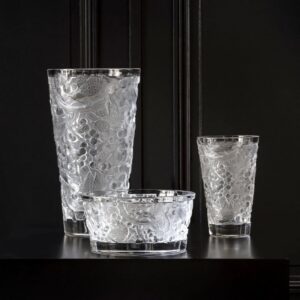 MERLES ET RAISINS bowl. In 1928, RENÉ LALIQUE designed the MERLES & RAISINS decorative panels, originally in created in pressed glass on a silver background and adorned the Cuban mahogany woodwork of the legendary Orient Express. Today, the Lalique Studio reinterprets this emblematic creation, in new expressions through vases and a bowl. The precious cultural heritage of the House thus comes to life in very contemporary shapes. Blackbirds with finely chiseled plumage indulge in an abundance of sweet grapes while the vines create an exceptional rhythm throughout a perfectly balanced composition. The richness of the decor conveys a sensation of profusion and of abundance. Highlighted by the purity of satin-finished crystal, signature of the House, these decorative objects brilliantly illustrate the timeless character of Lalique creations.