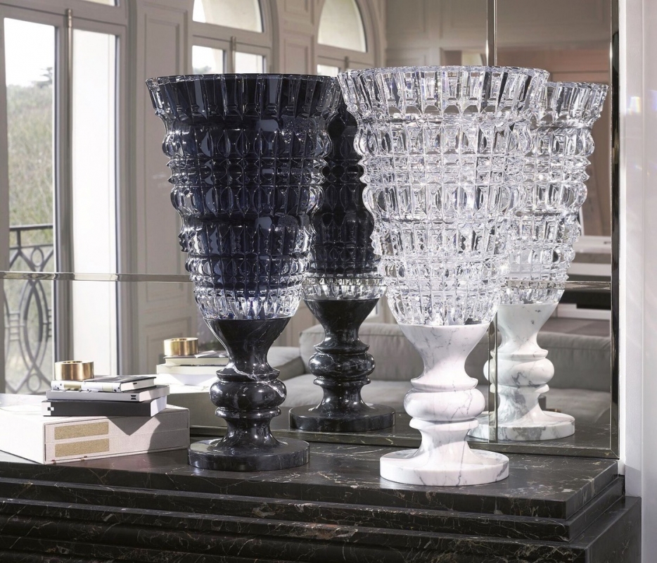 NEW ANTIQUE vase by MARCEL WANDERS STUDIO. This exquisite hand-blown clear crystal vase mounted on a stylish white marble base is available in a limited edition of 99 numbered pieces. MARCEL WANDERS STUDIO has drawn inspiration from classic pieces of decorative art and from his own Baroque world in creating a new collection of vases which is appropriately named NEW ANTIQUE. Each vase is blown and decorated with deep geometric cuts before being mounted on a black Italian marble base, much like a trophy. This clear crystal vase, decorated inside with black lacquer and criss-cross bevel cuts, is available in a limited edition of 99 numbered pieces signed Baccarat and MARCEL WANDERS STUDIO. It is an exquisite piece that will lend sumptuous splendour to any room.