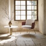 MERWYN lounge chair by SEBASTIAN HERKNER. The shell that SEBASTIAN HERKNER gives this quality core espouses a similar blend of traditional and contemporary strengths: the shape of the chair and sofa stirs up associations with classic armchairs and canap√©s. The precise upholstery is positioned above delicate, almost fragile-looking legs. By contrast, the piece‚Äôs modern, pared-down shape and thoroughly stable structure ‚Äì along with its pleasingly coherent proportions ‚Äì is a product of the complexity of knowledge and skill that goes into innovative design ideas.