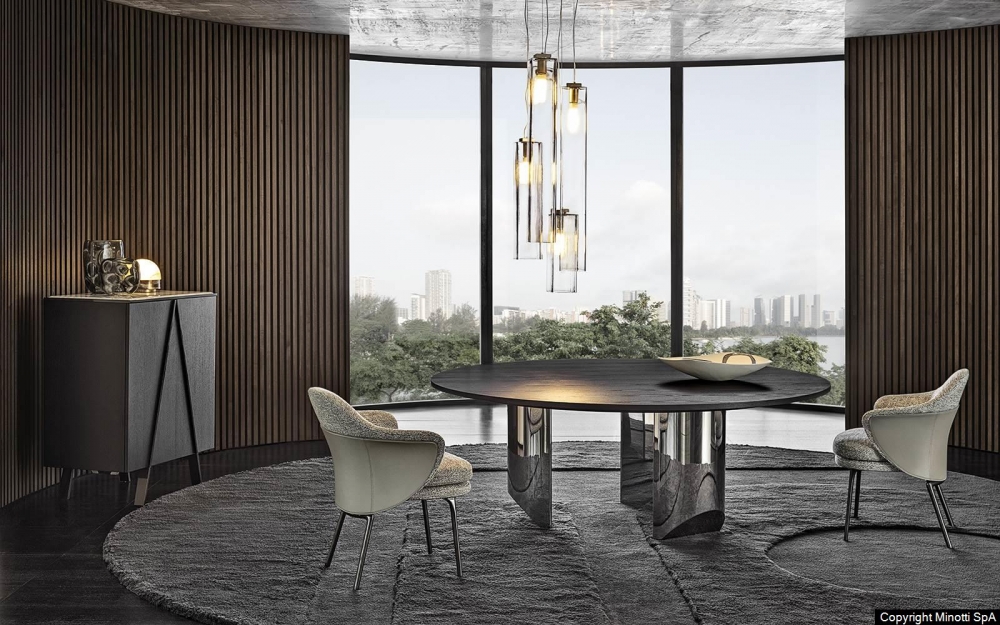 WEDGE DINING TABLE by NENDO, designed in 2019. WEDGE explores the concept of a table with a strong graphic style, offering both a dining room and coffee table version. In the dining table, the bulky look created by the solid sculptural masses of the semi-circular legs of wedge contrasts with the lightweight feet, which culminate in an oblique chisel tip shape. The entire volume of the table, hosting the large top, appears to become weightless and leans lightly on the tips of the legs, challenging the law of gravity. The element of surprise is even stronger in the version with barrel-shaped glass top, the surface of which reveals the semi-circles of the supports, positioned in a purposely irregular formation.
