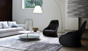DERBY armchair by NO√â DUCHAUFOUR LAWRENCE, designed in 2010. Armchair/berg√®re, pouf. Armchair with steel base, swivel or fixed with feet and stiff polyurethane external body covered with cowhide 95. Upholstery of internal body and pouf in polyurethane/ heat-bound polyester fibre with elastic strips suspension. Removable fabric or leather cover. Pouf steel frame.