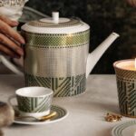 AUGUSTA collection.Featuring a captivating mosaic of gold, soft green, and emerald green, this collection of fine porcelain dinnerware pays homage to classical rigor with simplified motifs influenced by cubist geometry. While the AUGUSTA pieces are entirely functional as modern tableware, they also serve as decorative objects that capture the spirit of the Empire period. Collectors and enthusiasts of Napoleonic culture appreciate the collection for its ability to translate the aesthetic ideals of the early 19th century into timeless, elegant porcelain suitable for today’s interiors. In this way, the BERNARDAUD AUGUSTA collection stands not only as an example of excellent Limoges workmanship but also as a subtle homage to the artistic legacy of Napoleon’s empire.